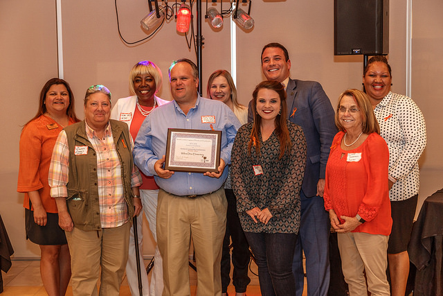 a group of awardees from a South Carolina school holding a plaque with SCPTA board members